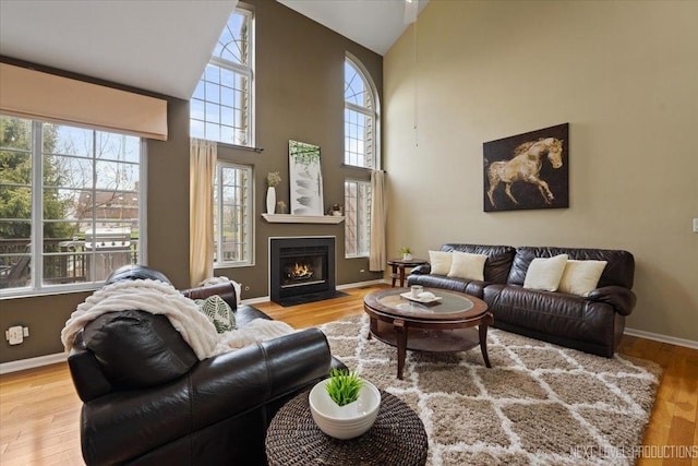 1839 Tamahawk Ln, Naperville, IL 60564 - living room with high vaulted ceiling, wood finished floors, a fireplace with flush hearth, and baseboards