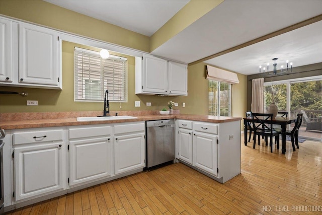 1839 Tamahawk Ln, Naperville, IL 60564 - kitchen featuring stainless steel dishwasher, a sink, a chandelier, and white cabinetry