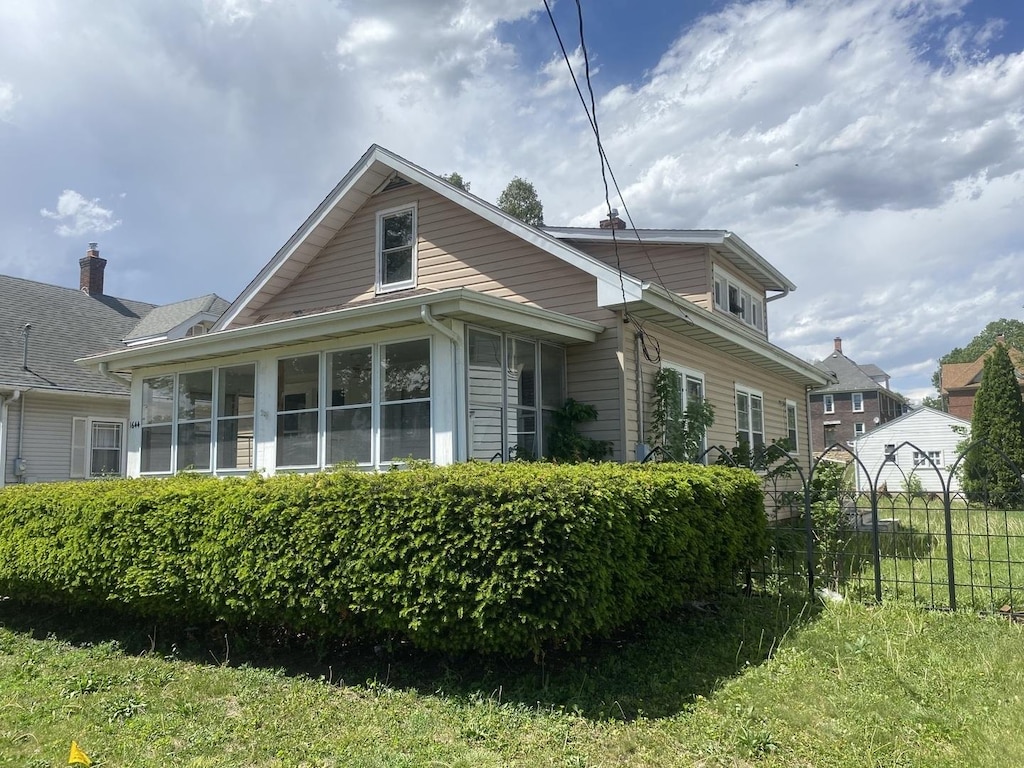 1644 6th Ave, Rockford, IL 61104 - view of property exterior with a sunroom