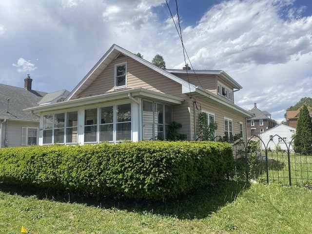 1644 6th Ave, Rockford, IL 61104 - view of property exterior with a sunroom