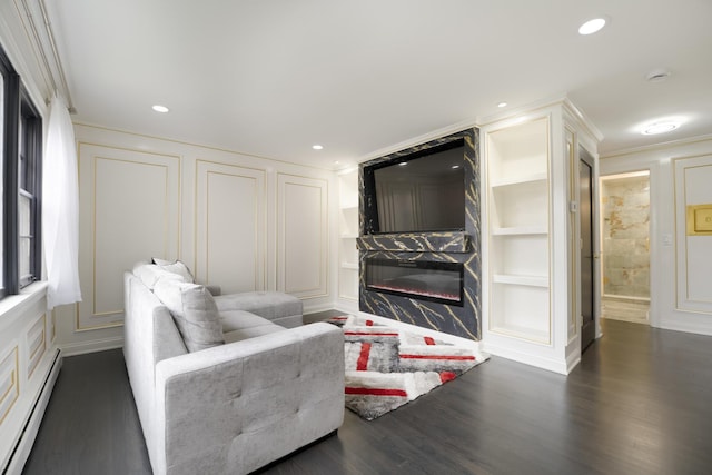 6964 W Diversey Ave Unit 6, Chicago, IL 60707 - living area with a baseboard heating unit, a premium fireplace, a decorative wall, dark wood-style floors, and built in shelves