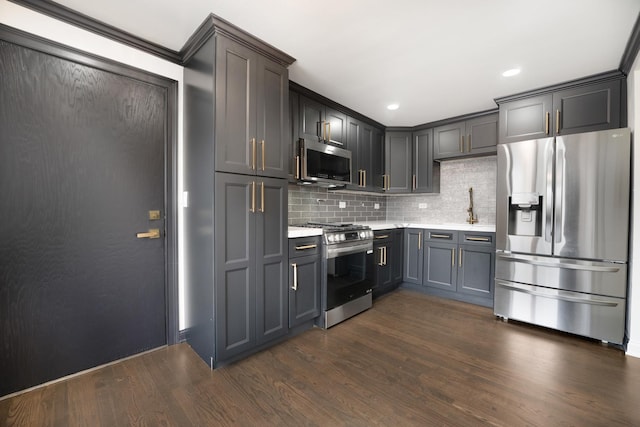 6964 W Diversey Ave Unit 6, Chicago, IL 60707 - kitchen with stainless steel appliances, light countertops, decorative backsplash, dark wood-style floors, and a sink