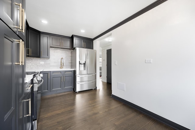 6964 W Diversey Ave Unit 6, Chicago, IL 60707 - kitchen featuring stainless steel appliances, light countertops, decorative backsplash, dark wood-style floors, and baseboards