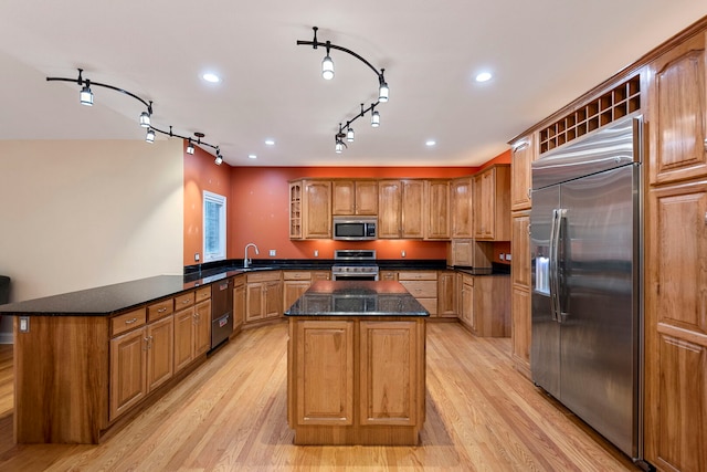 1912 Indian Trl, Kankakee, IL 60901 - kitchen featuring stainless steel appliances, a sink, a kitchen island, a peninsula, and glass insert cabinets
