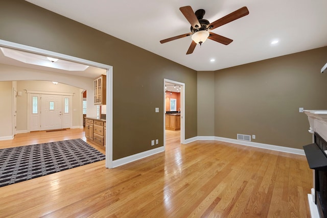 1912 Indian Trl, Kankakee, IL 60901 - unfurnished living room featuring light wood-style flooring, ceiling fan, baseboards, arched walkways, and recessed lighting