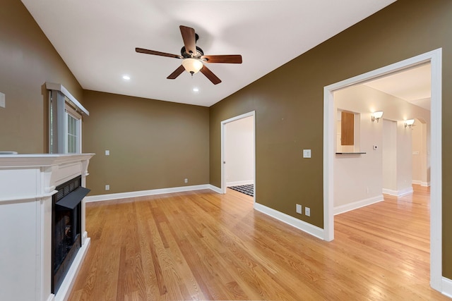 1912 Indian Trl, Kankakee, IL 60901 - unfurnished living room with ceiling fan, light wood finished floors, a fireplace with raised hearth, baseboards, and recessed lighting