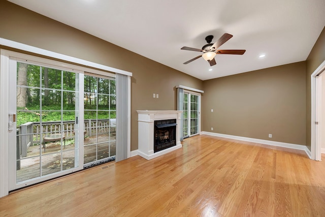 1912 Indian Trl, Kankakee, IL 60901 - unfurnished living room featuring a ceiling fan, baseboards, light wood-type flooring, a fireplace, and recessed lighting