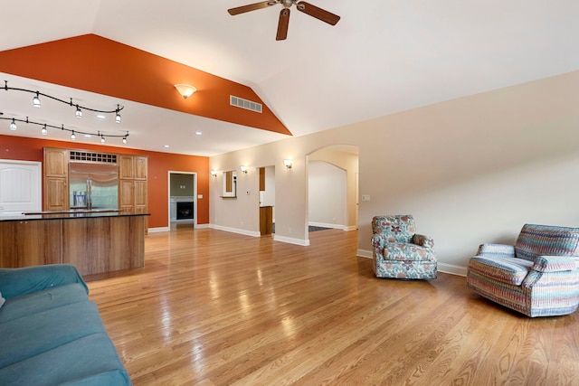 1912 Indian Trl, Kankakee, IL 60901 - living area with a ceiling fan, lofted ceiling, light wood finished floors, baseboards, and arched walkways