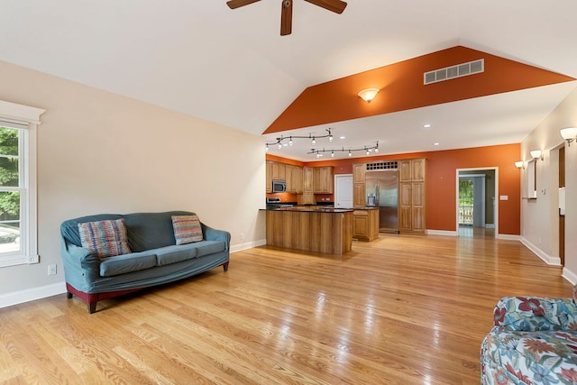 1912 Indian Trl, Kankakee, IL 60901 - living area with light wood-style flooring, vaulted ceiling, healthy amount of natural light, ceiling fan, and baseboards