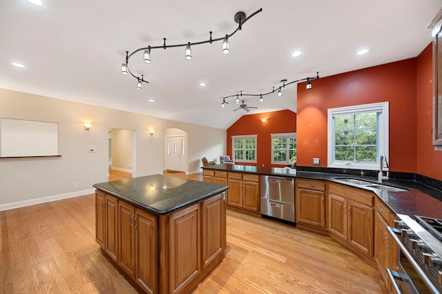 1912 Indian Trl, Kankakee, IL 60901 - kitchen with stainless steel appliances, a sink, light wood finished floors, brown cabinets, and vaulted ceiling