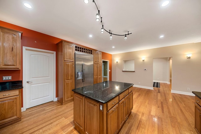 1912 Indian Trl, Kankakee, IL 60901 - kitchen featuring built in fridge, light wood-type flooring, a kitchen island, brown cabinetry, and baseboards
