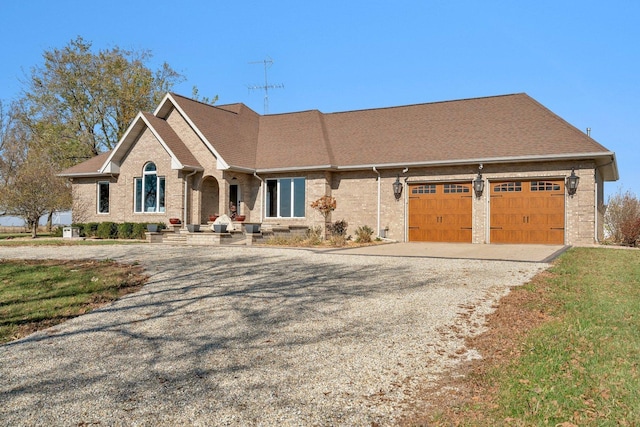 10739 E 3200 N Rd, Blackstone, IL 61313 - view of front of property featuring driveway, a garage, and brick siding