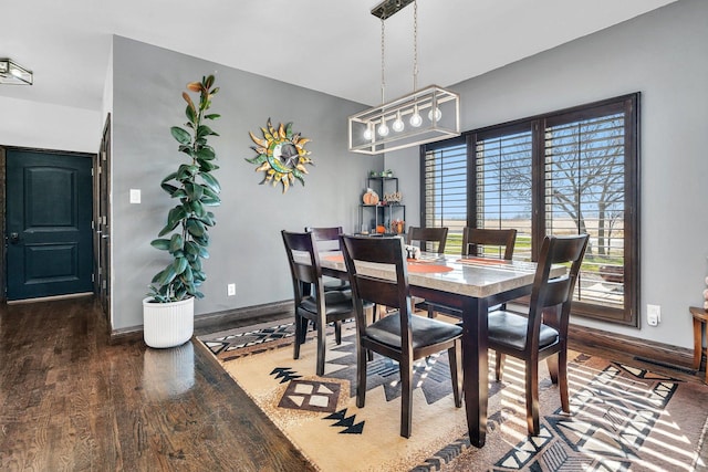 10739 E 3200 N Rd, Blackstone, IL 61313 - dining area featuring wood finished floors, baseboards, and a chandelier