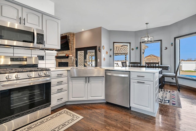 10739 E 3200 N Rd, Blackstone, IL 61313 - kitchen featuring stainless steel appliances, a sink, dark wood-type flooring, light countertops, and recessed lighting