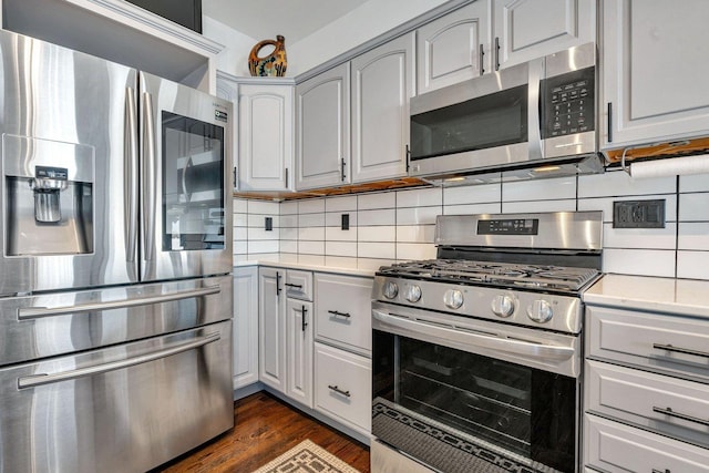 10739 E 3200 N Rd, Blackstone, IL 61313 - kitchen with stainless steel appliances, light countertops, decorative backsplash, and dark wood-style flooring
