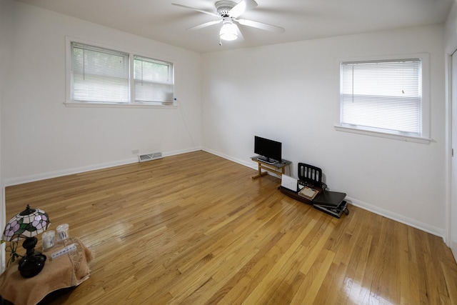 1065 Irwin Ave, Des Plaines, IL 60018 - empty room with healthy amount of natural light, light wood-style floors, a ceiling fan, and baseboards