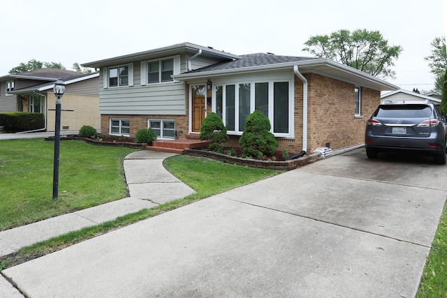 1065 Irwin Ave, Des Plaines, IL 60018 - split level home with brick siding, a front lawn, and driveway