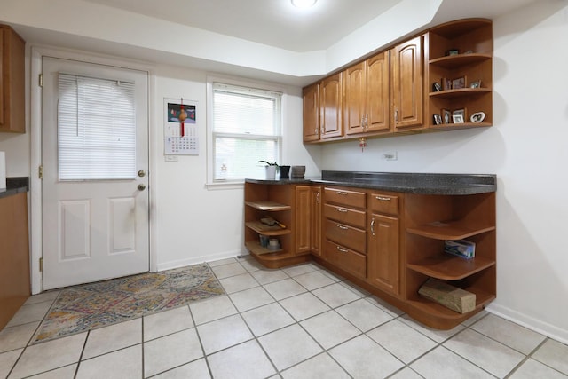 1065 Irwin Ave, Des Plaines, IL 60018 - kitchen featuring open shelves, brown cabinetry, dark countertops, and baseboards