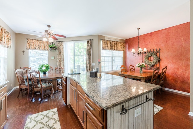 601 Pheasant Trl, Saint Charles, IL 60174 - kitchen with dark wood finished floors, baseboards, a ceiling fan, light stone countertops, and brown cabinetry