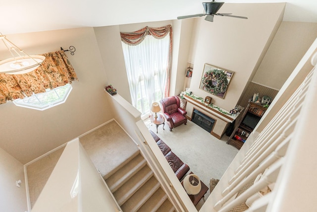 601 Pheasant Trl, Saint Charles, IL 60174 - staircase with carpet flooring, a ceiling fan, and a fireplace