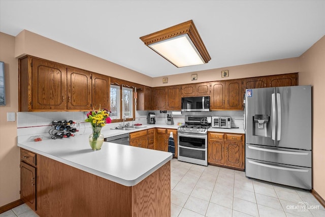 1359 Pine St, Batavia, IL 60510 - kitchen with appliances with stainless steel finishes, a peninsula, light countertops, a sink, and light tile patterned floors