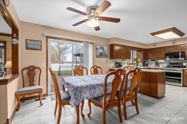 1359 Pine St, Batavia, IL 60510 - dining space with ceiling fan, light tile patterned floors, and baseboards