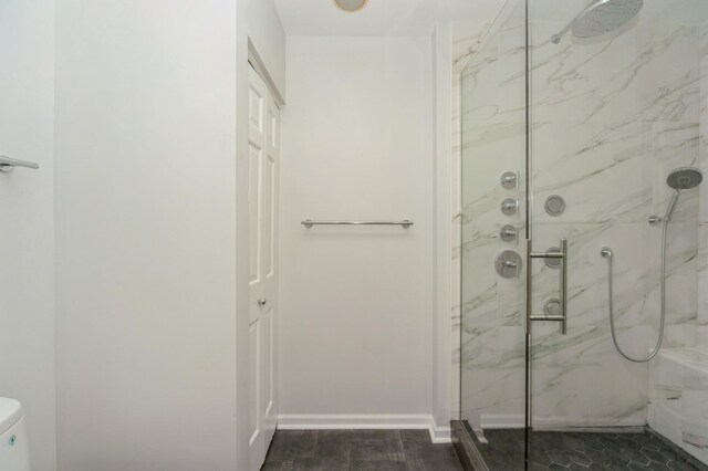 3950 Dundee Rd Unit 101, Northbrook, IL 60062 - bathroom featuring a marble finish shower, toilet, baseboards, and wood finished floors