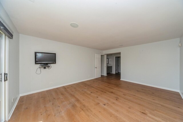 3950 Dundee Rd Unit 101, Northbrook, IL 60062 - unfurnished living room featuring light wood finished floors and baseboards