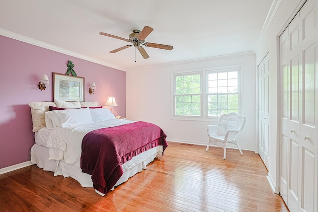 1730 Napoleon Dr, Naperville, IL 60565 - bedroom featuring ornamental molding, light wood-type flooring, baseboards, two closets, and ceiling fan