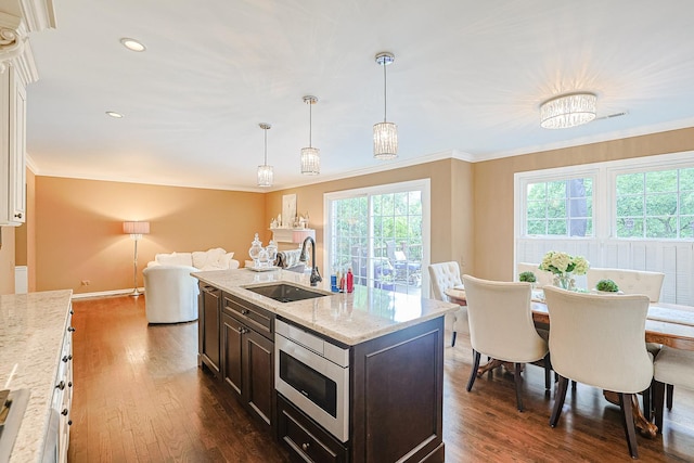 1730 Napoleon Dr, Naperville, IL 60565 - kitchen with a sink, stainless steel microwave, dark wood-style flooring, dark brown cabinetry, and ornamental molding
