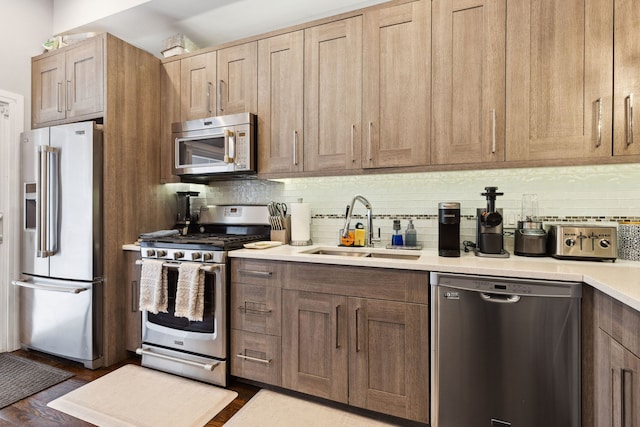 4331 S Evans Ave, Chicago, IL 60653 - kitchen with stainless steel appliances, a sink, decorative backsplash, and light countertops