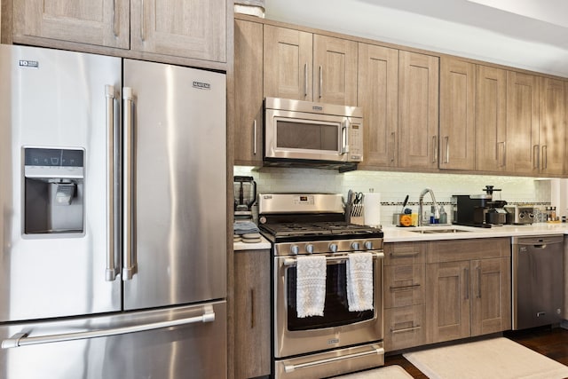 4331 S Evans Ave, Chicago, IL 60653 - kitchen with appliances with stainless steel finishes, a sink, light countertops, and decorative backsplash