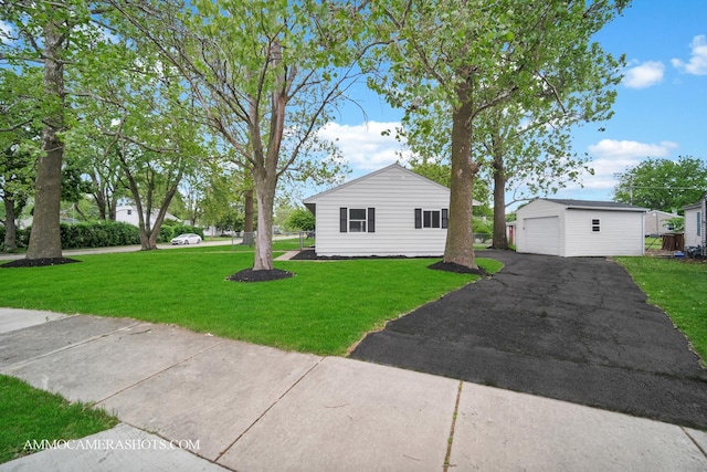 1306 Schriber Ave, Joliet, IL 60435 - view of home's exterior featuring a detached garage, an outbuilding, asphalt driveway, and a lawn