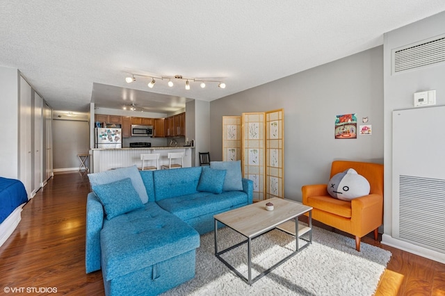 474 N Lake Shore Dr Unit 1701, Chicago, IL 60611 - living area featuring dark wood-style flooring, baseboards, a heating unit, and a textured ceiling