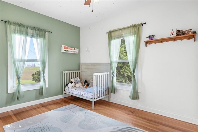 32900 N 2000 E Rd, Dwight, IL 60420 - bedroom with wood finished floors, baseboards, a crib, and a ceiling fan