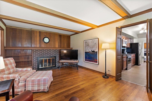 20424 Ithaca Rd, Olympia Fields, IL 60461 - living area featuring beamed ceiling, a brick fireplace, wood finished floors, and baseboards