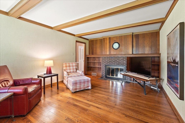 20424 Ithaca Rd, Olympia Fields, IL 60461 - living area featuring beamed ceiling, a brick fireplace, wood finished floors, and wood walls