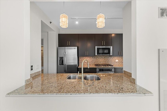 505 N Mcclurg Ct Unit 2003, Chicago, IL 60611 - kitchen featuring stainless steel appliances, a sink, a peninsula, backsplash, and light stone counters