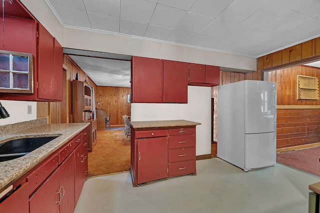 170 E Church St, Coal City, IL 60416 - kitchen featuring freestanding refrigerator, red cabinetry, wood walls, light countertops, and ornamental molding