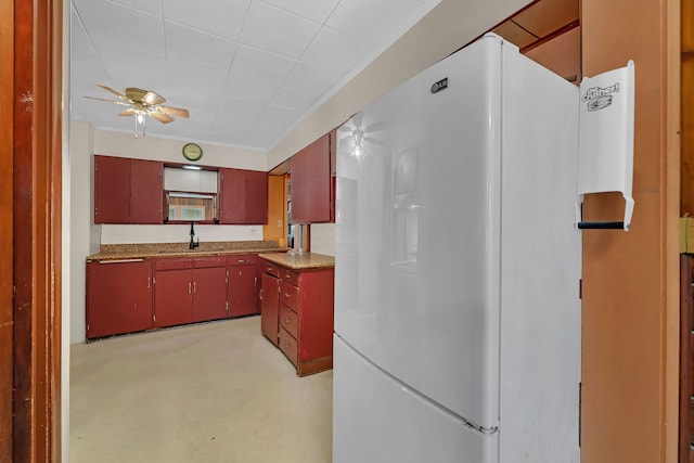170 E Church St, Coal City, IL 60416 - kitchen with freestanding refrigerator, red cabinetry, ceiling fan, and finished concrete floors