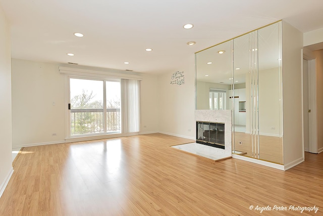 300 E Dundee Rd Unit 402, Buffalo Grove, IL 60089 - unfurnished living room with baseboards, light wood-type flooring, recessed lighting, and a premium fireplace