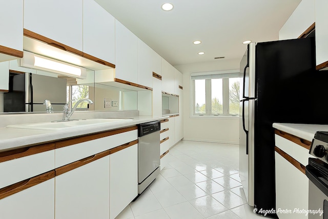 300 E Dundee Rd Unit 402, Buffalo Grove, IL 60089 - kitchen featuring dishwasher, white cabinets, light countertops, recessed lighting, and a sink