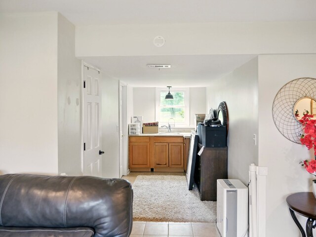 500 Muscovy Ln, Bloomingdale, IL 60108 - interior space featuring brown cabinets, light tile patterned floors, light countertops, a sink, and pendant lighting