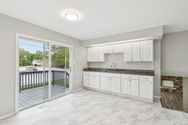 18951 Willow Ave, Country Club Hills, IL 60478 - kitchen with a sink, baseboards, backsplash, and white cabinets