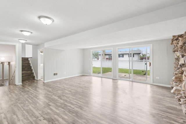 18951 Willow Ave, Country Club Hills, IL 60478 - unfurnished living room with wood finished floors, healthy amount of natural light, stairway, and wooden walls