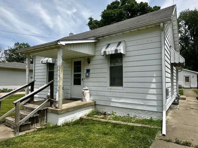 918 N Elizabeth St, Clinton, IL 61727 - view of front facade featuring a shingled roof and a front lawn