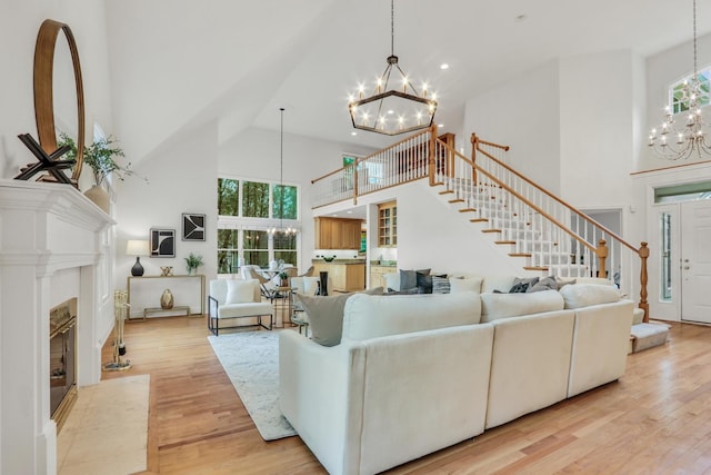 1700 Cornell Ct, Lake Forest, IL 60045 - living area with a chandelier, high vaulted ceiling, stairway, a fireplace, and wood finished floors