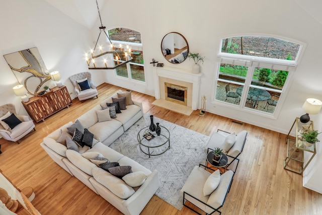 1700 Cornell Ct, Lake Forest, IL 60045 - living area with a chandelier, a fireplace, a high ceiling, and wood finished floors