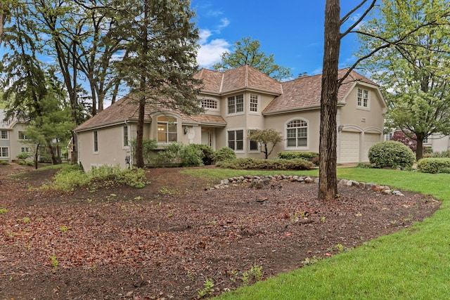 1700 Cornell Ct, Lake Forest, IL 60045 - tudor-style house featuring stucco siding and a garage