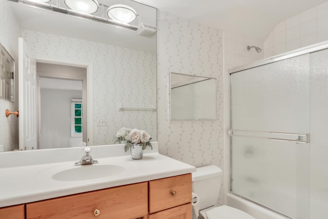 1700 Cornell Ct, Lake Forest, IL 60045 - full bathroom featuring wallpapered walls, vanity, toilet, combined bath / shower with glass door, and lofted ceiling